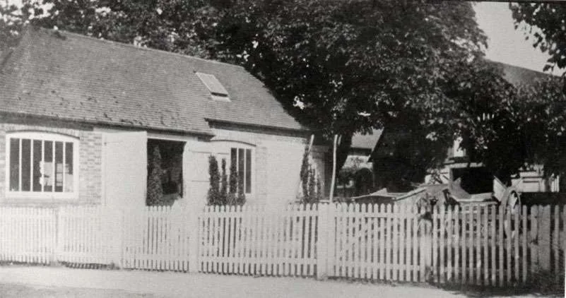 The wheelwrights own forge, built after 1893, with wagons and carts in the yard