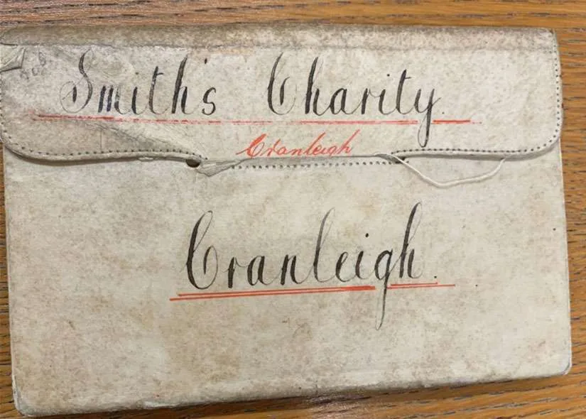 The cover of the Minute Book of the Smiths Charity Cranleigh