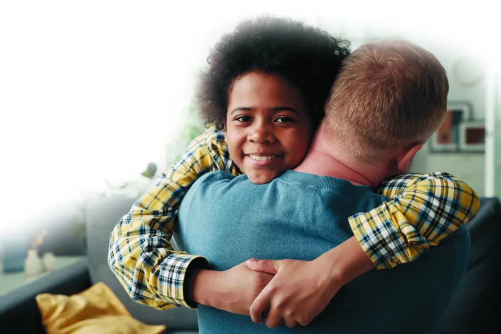 Adoptive boy embracing his foster dad