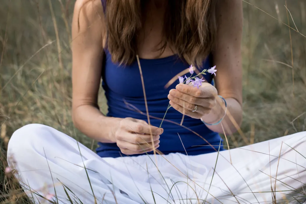 Close up of female hands holding wild flower