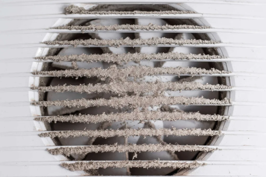 The white grille for the exhaust fan is dirty. Concept of indoor air pollution.