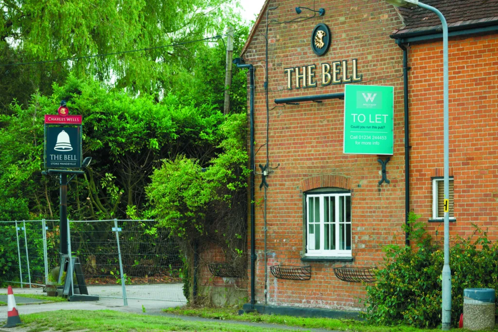 Exterior of closed down British pub with to let sign, UK