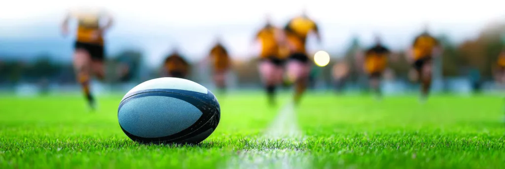Rugby Ball on Field – Close up of a rugby ball on a grassy field
