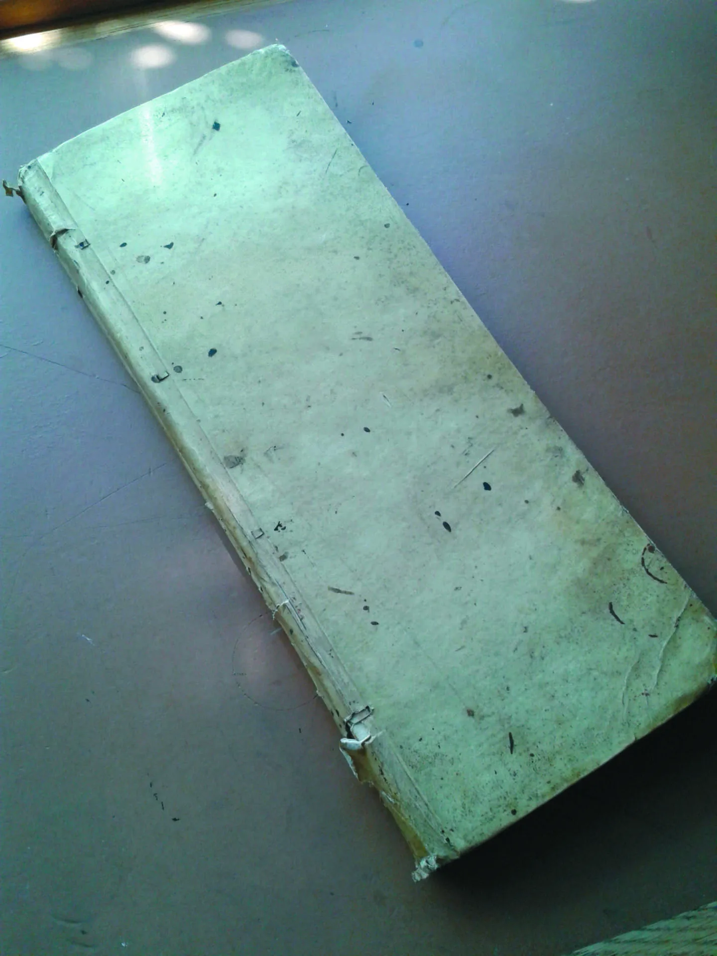 The worn vellum cover of James Puttock's early 19th-century ledger book.