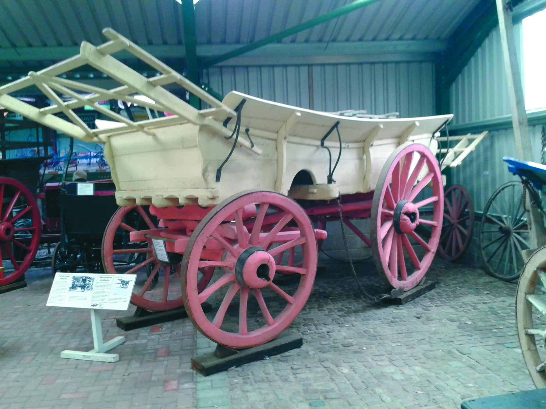A restored farm wagon painted in traditional Surrey colours at Tilford.