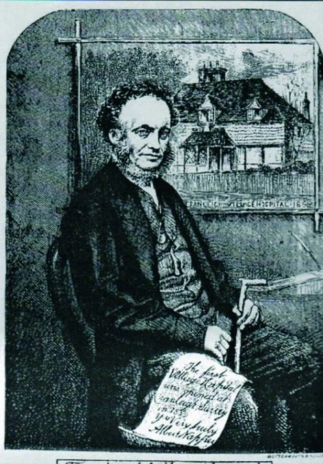 An engraving of Dr Albert Napper seated, holding papers, with a picture of the first village hospital behind him