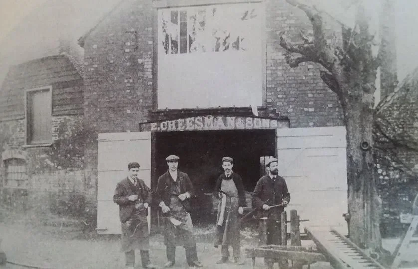 The Cheesman family standing in the wheelwright's yard in the early 1900s