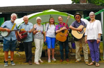 Musicians performing acoustic music at Cranleigh Folk Club