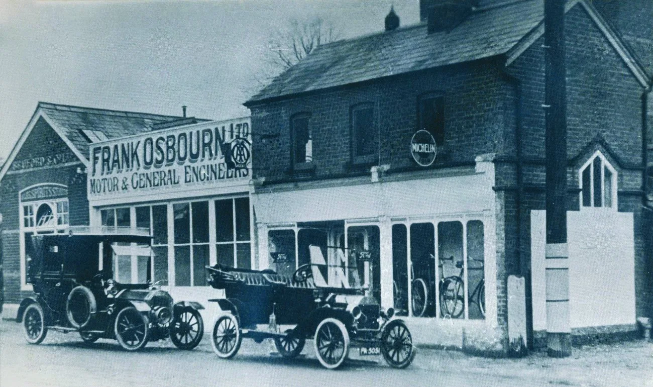 Osbourn's garage in 1913 with cars and bicycles for sale