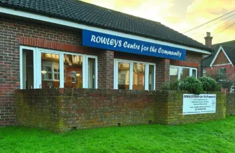 The Rowleys Centre for the Community building in Cranleigh, with its blue sign above the windows