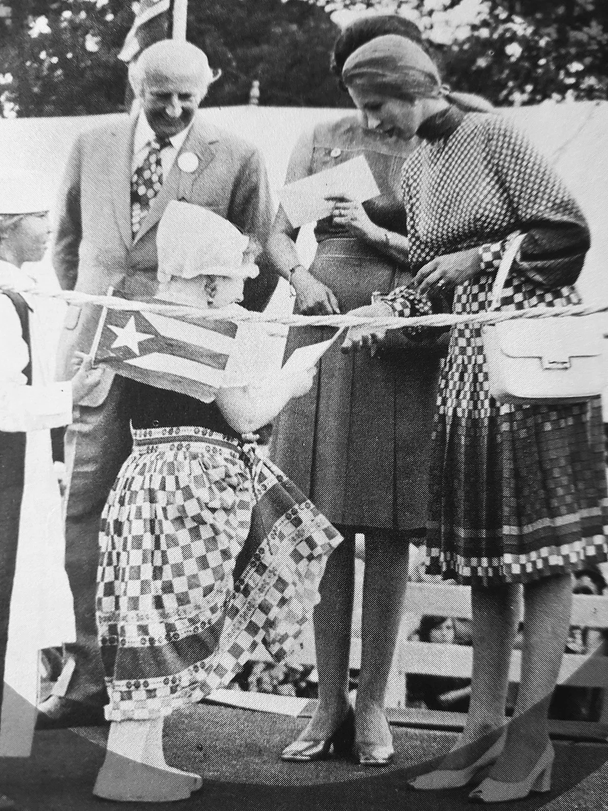 A small girl handing Princess Anne a gift for Save the Children in 1975