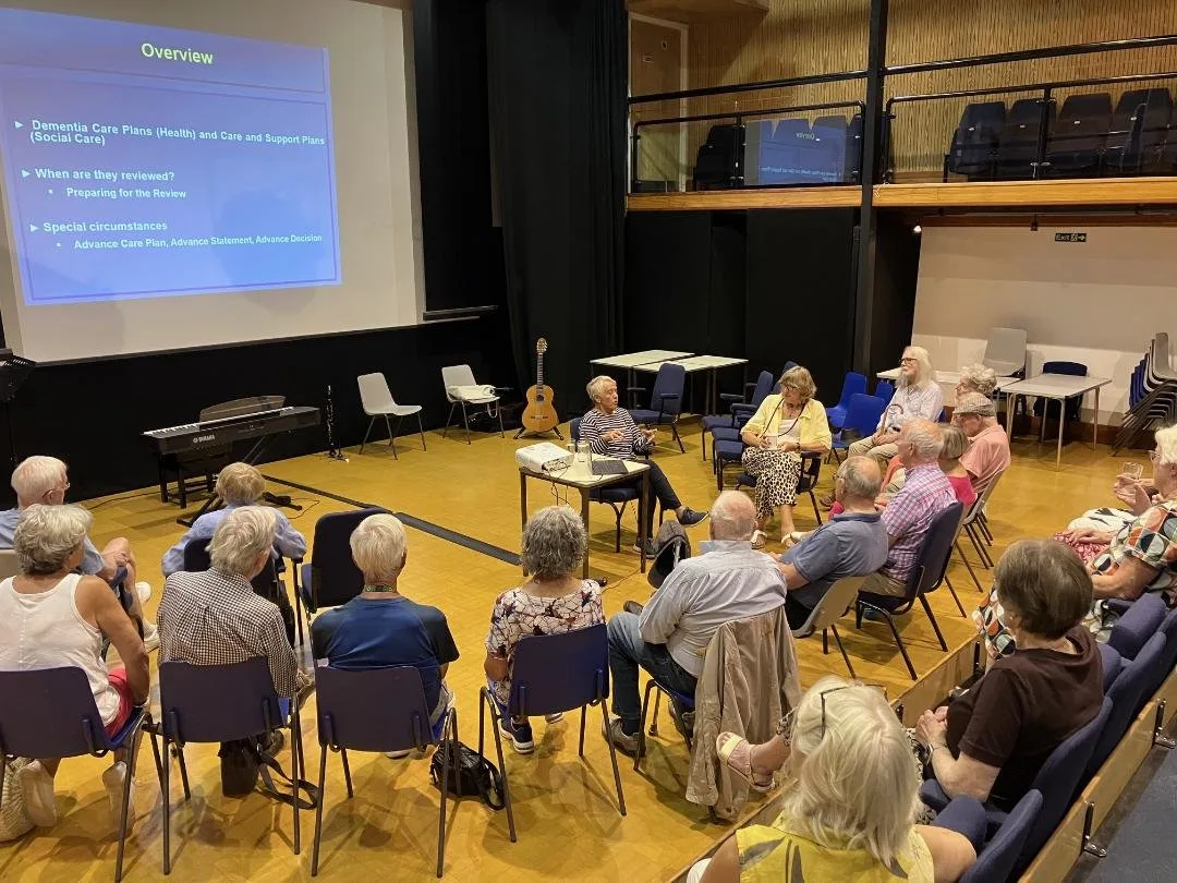 Memory Lane guests seated in Cranleigh Arts Centre for a presentation shown on a large screen