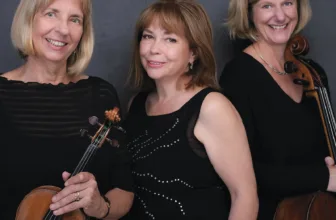 The three members of the Mordkovitch Trio, two of them holding a violin and a cello