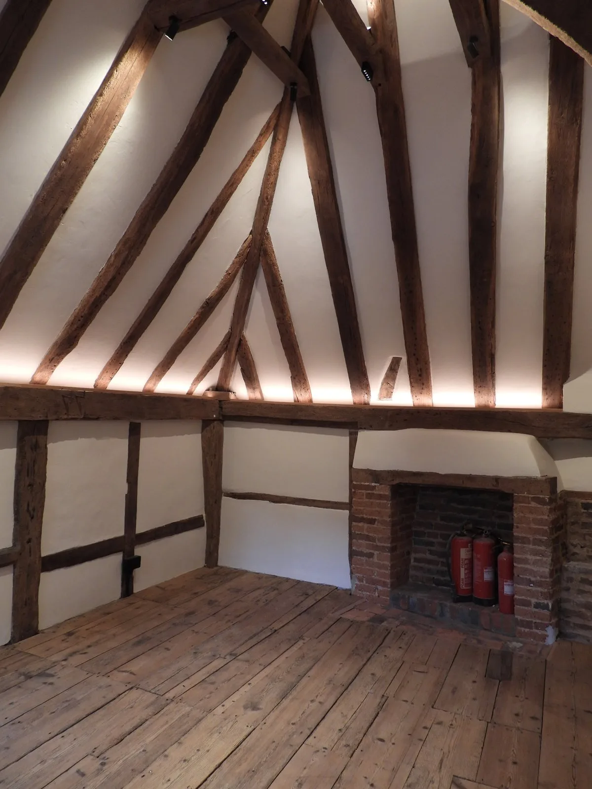 The Elizabeth Smith room upstairs in the Napper Centre, with exposed timber beams and a brick fireplace