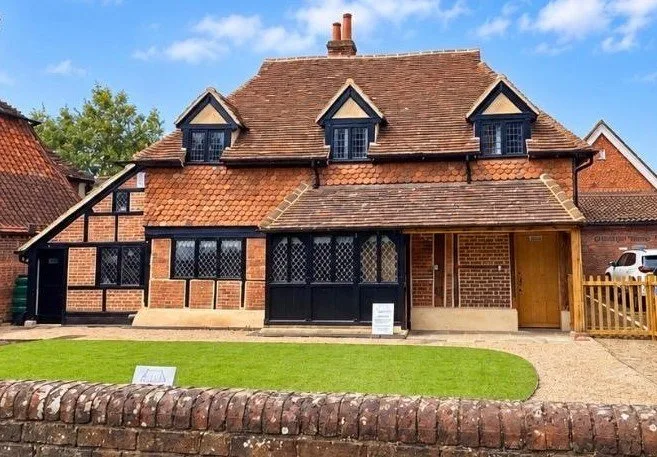 The restored Napper Centre cottage on Cranleigh High Street, with a new lawn in front
