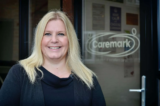 Local business owner supporting elderly during winter